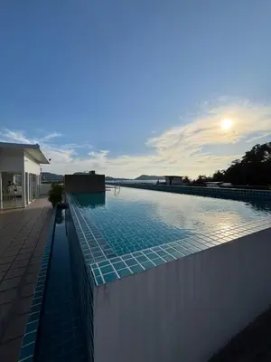 a swimming pool with a sunset in the background at 3 Beds patong baycleef residence in Patong Beach