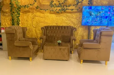 three chairs and a table in front of a wall at Tiger Complex Inn in Patong Beach
