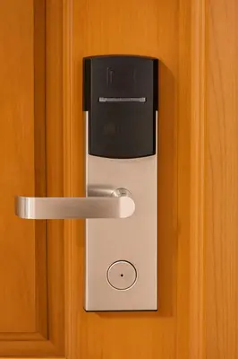 a lock on a wooden door with a microwave at Tiger Complex Inn in Patong Beach