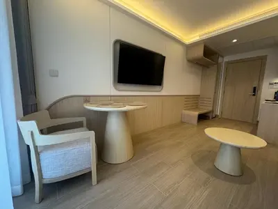 a room with a table and a tv on the wall at Apartment Wyndham Naithon in Nai Thon Beach