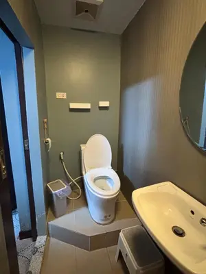 a bathroom with a toilet and a sink at Milos House in Phuket Town