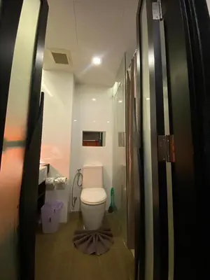 a bathroom with a toilet and a shower at The Beach Condotel Kata in Kata Beach