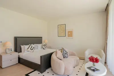 a bedroom with a bed and a chair at Villa Belle Air Panwa Beachfront 6BR Breakfast included in Ban Ao Makham