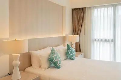 a bedroom with a white bed with pillows and a window at Villa Belle Air Panwa Beachfront 6BR Breakfast included in Ban Ao Makham