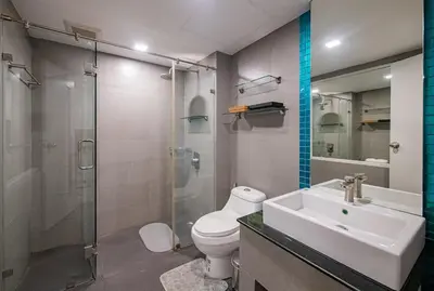 a bathroom with a toilet and a sink and a shower at the Kris Bangtao Phuket not in laguna area in Laguna Phuket