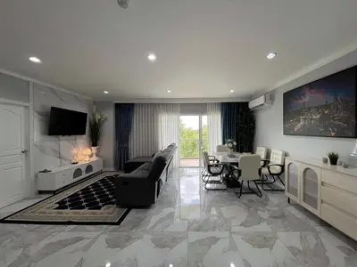 a large living room with a couch and a table at Green place condominium in Ban Lo Long