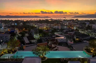 a view of a city at sunset at HOMA Chalong Bay in Ban Klang