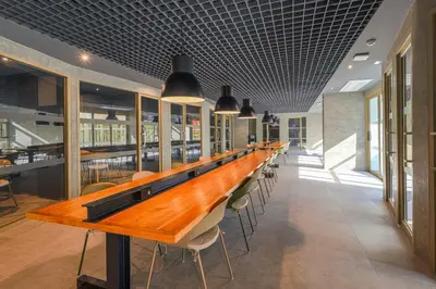 a long table in a restaurant with chairs at HOMA Chalong Bay in Ban Klang