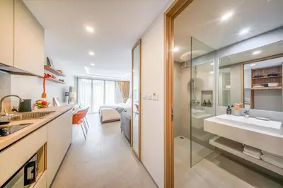 a bathroom with a sink and a glass shower at HOMA Chalong Bay in Ban Klang