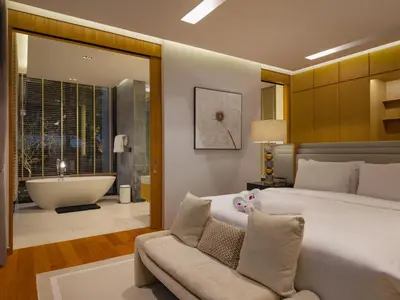 a bedroom with a large bed and a bath tub at Luxury 4BR Pool Villa in Botanica - Villa Boa in Ban Phru Champa