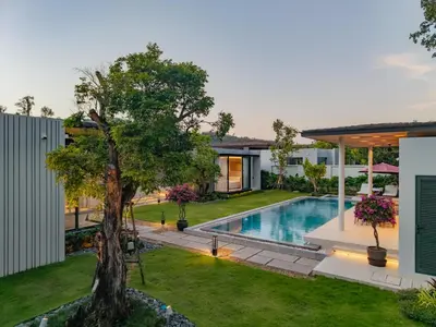 an image of a backyard with a swimming pool and a tree at Luxury 4BR Pool Villa in Botanica - Villa Boa in Ban Phru Champa