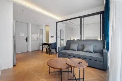 a living room with a couch and a table at Beachfront 1 Bedroom 361 Condo Kora Resort in Phuket Town
