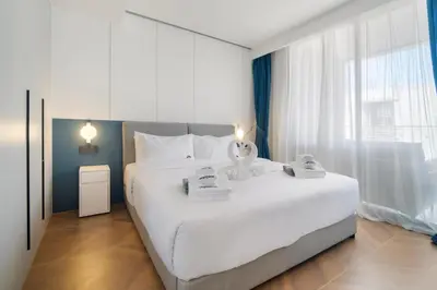 a bedroom with a large white bed and a large window at Beachfront 1 Bedroom 361 Condo Kora Resort in Phuket Town