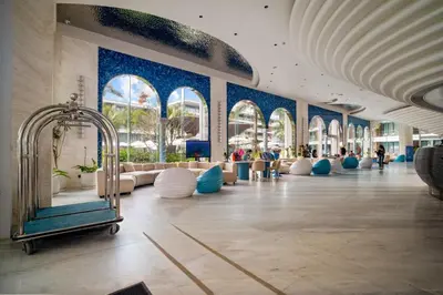 a lobby of a building with blue walls and windows at Beachfront 1 Bedroom 361 Condo Kora Resort in Phuket Town