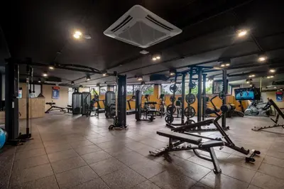 a gym with a bunch of treadmills and machines at Kora Beachfront 240 One Bedroom Apartment Phuket in Phuket Town