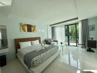 a bedroom with a bed and a glass table at Modern 1 Bedroom Apartment - At The Tree Rawai in Rawai Beach