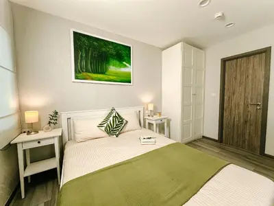 a bedroom with a bed and a picture on the wall at Cozy 1BR Tropical View at Title in Nai Yang Beach