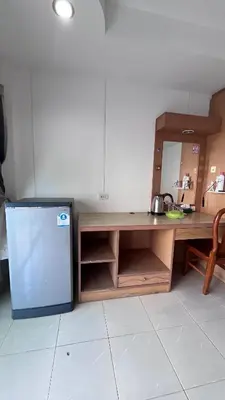 a kitchen with a table and a refrigerator at Smile room 21 in Patong Beach