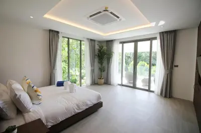 a bedroom with a large bed and a large window at Modern Private Pool Villa - Peaceful Kamala Stay in Kamala Beach