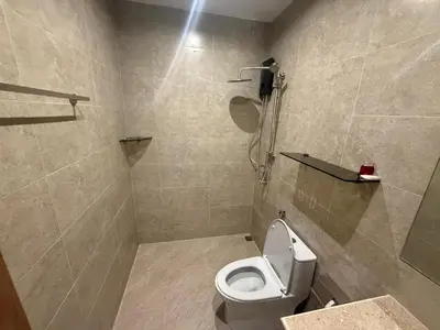 a bathroom with a white toilet and a shower at RK Boutique rooms in Patong Beach