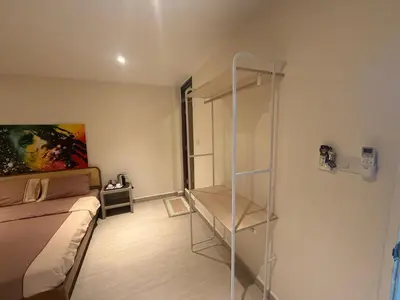 a small room with a bed and a glass shelf at RK Boutique rooms in Patong Beach