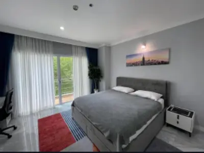 a bedroom with a bed and a large window at Phuket 402 in Phuket Town