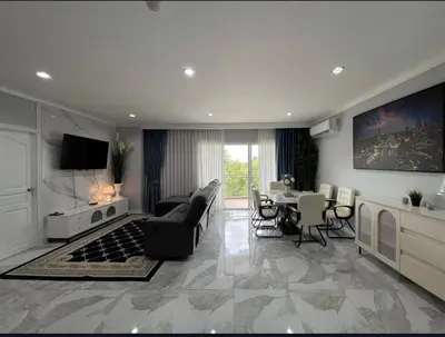 a living room with a couch and a table at Phuket 402 in Phuket Town