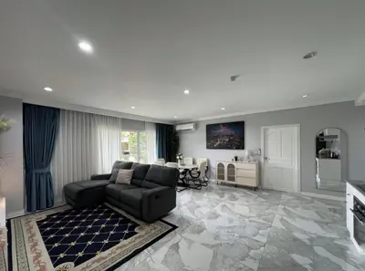 a large living room with a couch and a table at Phuket 402 in Phuket Town
