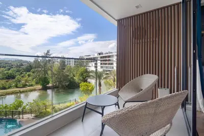 a balcony with chairs and a view of a river at Premier Pool View Studio 348 Kora Resort in Phuket Town