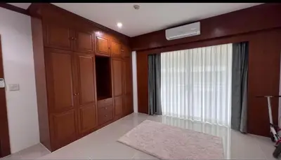 a living room with a large window and a sliding door at Phuket 604 in Phuket Town