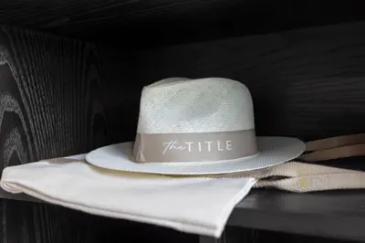 a white hat sitting on top of a table at Porto 1BR Pool Access Suite at Title Legendary in Bang Tao Beach