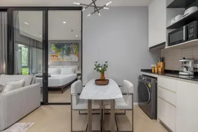 a kitchen and living room with a table and a couch at Porto 1BR Pool Access Suite at Title Legendary in Bang Tao Beach