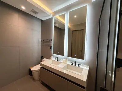 a bathroom with a sink and a toilet and a mirror at Clover Residence Villa Phuket in Koh Lone