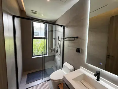 a bathroom with a shower and a toilet and a sink at Clover Residence Villa Phuket in Koh Lone