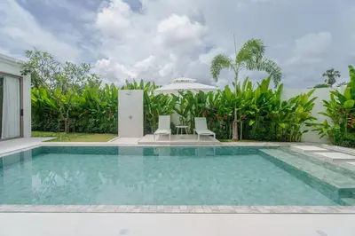 a swimming pool in front of a villa at Brand New Asherah Pool Villa next to Bangtao Beach VVPHU52 in Ban Riang