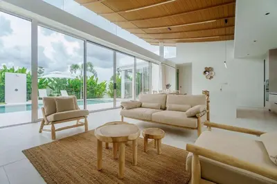 a living room with a couch and a table at Brand New Asherah Pool Villa next to Bangtao Beach VVPHU52 in Ban Riang
