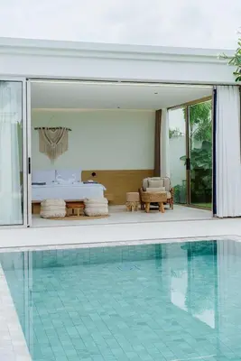 a swimming pool next to a hotel room with a bed at Brand New Asherah Pool Villa next to Bangtao Beach VVPHU52 in Ban Riang