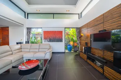 a living room with a couch and a flat screen tv at BangTao 3 Bedrooms Bali Tropical Pool Villa Quiet Private Space Guest Preferred in Bang Tao Beach