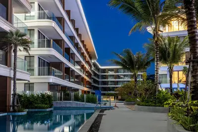 an apartment building with a swimming pool and palm trees at KORA 2BR LUXURY POOL VIEW Apartment in Layan Beach