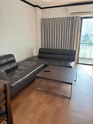 a living room with a leather couch and a coffee table at Apartment in Patong Beach in Patong Beach