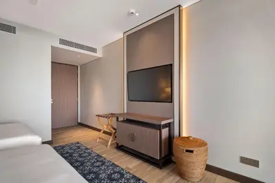 a hotel room with a bed and a flat screen tv at Angsana Oceanview Residences Building 2 in Laguna by Banyan Living in Thalang