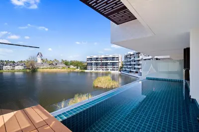 a swimming pool with a view of a body of water at Angsana Oceanview Residences Building 2 in Laguna by Banyan Living in Thalang