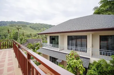 a balcony of a house with a view of the mountains at B201 Banjong Studio 3 Minutes To Nai Harn Beach in Rawai Beach