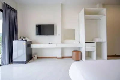 a white room with a television and a bed at B203 Banjong Studio 3 Minutes To Nai Harn Beach in Rawai Beach