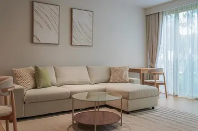 a living room with a couch and a table at Brand New Premium beachfront apartments! in Bang Tao Beach
