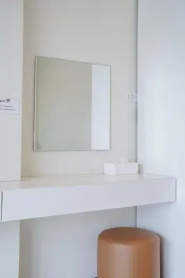 a white desk with a mirror and a brown stool at B204 Banjong Studio 3 Minutes To Nai Harn Beach in Rawai Beach