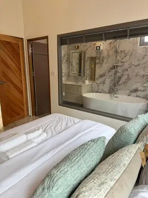 a bedroom with a large bed and a bath tub at Santong Villa Rawai in Rawai Beach