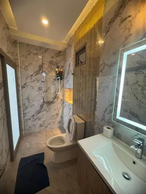 a bathroom with a toilet and a sink and a shower at Santong Villa Rawai in Rawai Beach