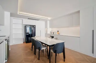 a kitchen and dining room with a table and chairs at Premier Kora 3-Bedroom Apartment E333 Beachfront in Phuket Town