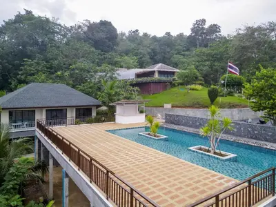 a view of a pool from the balcony of a house at A101 Banjong 1 Bed apart Near Nai Harn Beach in Rawai Beach